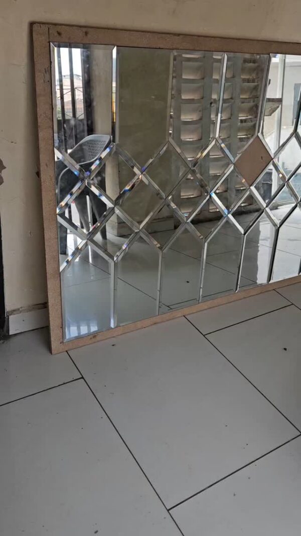 Custom bevelled mirror wall installation in a modern Nairobi living room by Jobel Services